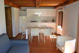a kitchen and dining room with a table and chairs at Il Borgo Antico in Cadarese