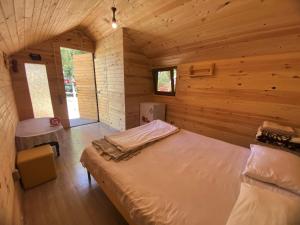 a bedroom with a bed in a wooden cabin at Anabella Sevan - Коттеджи рядом с озером Севан (Sevanavanq) in Sevan