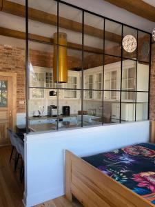 a kitchen with a counter with glass walls at Apartments PSD - Anny Łajming 2B in Słupsk +11 photos