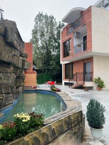 a swimming pool in a yard next to a building at Villa for families and friends 1 in Tbilisi City