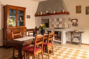 a kitchen with a table and chairs and a fireplace at Palazzo Micheletti Lucca in Lucca