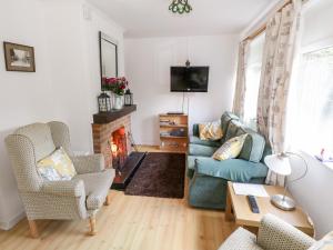 sala de estar con sofá y chimenea en Lakeside en Ballinrobe