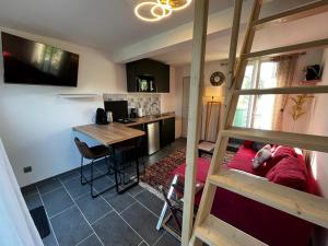 a living room with a bunk bed and a kitchen at Maison a coté de Giverny in Saint-Pierre-dʼAutils
