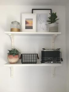 a shelf with a toaster and a toaster oven on it at Cedar Shade Cottage Ensuite Private Annexe with Parking in Sidmouth