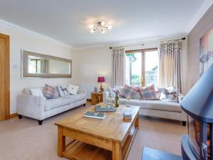 a living room with a couch and a table at The Lookout in Aviemore