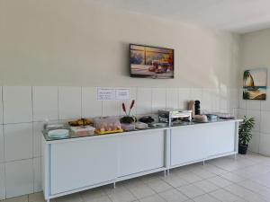 a counter in a room with food on it at Hotel Ouro Preto in João Pessoa