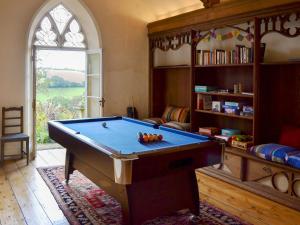 a living room with a pool table in it at The Old Vicarage in Helford