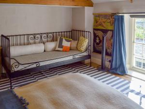 a room with a bench with pillows and a window at The Old Vicarage in Helford