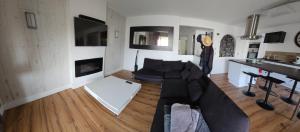 a living room with a couch and a table at Le Faust in Valence