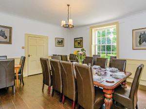 a dining room with a table and chairs at Lode Hall in Upwell