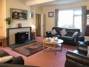 a living room with a couch and a fireplace at Mountain Cross in Gatehouse of Fleet