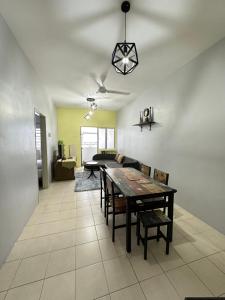 a living room with a table and a couch at Triple J in Cameron Highlands