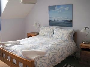 a bedroom with a bed with a picture on the wall at Dunmaghlas in Pirnmill