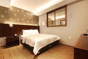 Postel nebo postele na pokoji v ubytování Hotel MoMo