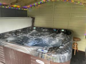 a jacuzzi tub in a room with a table at The Firkin Lodge in Whaplode