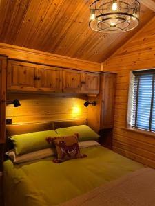 a bedroom with a bed in a wooden cabin at The Firkin Lodge in Whaplode