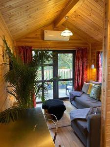 uma sala de estar com um sofá e uma mesa em The Firkin Lodge em Whaplode