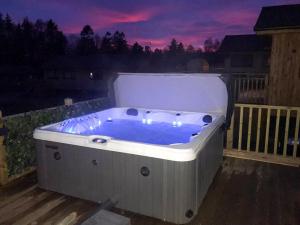 a jacuzzi tub on a deck at night at The Bunker in Otterburn