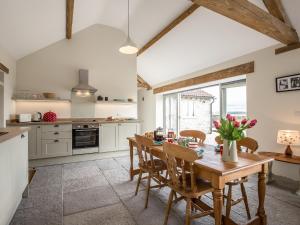 a kitchen with a wooden dining table and chairs at Long Barn - Ukc2870 in Baltonsborough