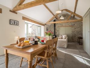 a dining room with a wooden table and chairs at Long Barn - Ukc2870 in Baltonsborough