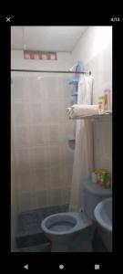 a bathroom with a blue toilet and a sink at Home Puerto carreño vichada in Cerro el Bita