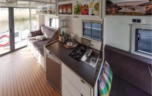 a kitchen and living room in an rv at Beautiful Ship In Havelsee With House Sea View in Kützkow