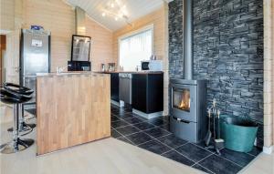a fireplace in a room with a stone wall at 3 Bedroom Gorgeous Home In Skjern in Lem