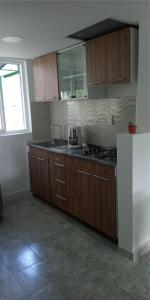 薩蘭托的住宿－Macondo casa café，厨房配有木制橱柜和炉灶烤箱。