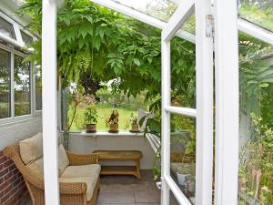 a conservatory with a window and plants at Bella Vista in Ryde