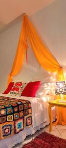 a bedroom with a bed with an orange canopy at Estância Villa Ventura in Socorro