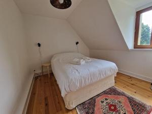 una piccola camera da letto con un letto in mansarda di Maison de charme pour 4 personnes, calme a Fay