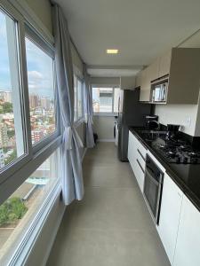 a kitchen with a view of a city at 4 Apartamentos amplos e novos, 86m e 45m, excelente localização, garagem, 350Mb de internet in Bento Gonçalves