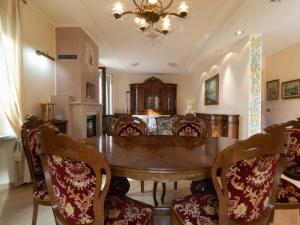 a dining room with a wooden table and chairs at Villa Roberta in Mandello del Lario
