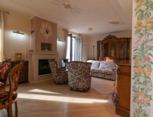 a living room with chairs and a fireplace at Villa Roberta in Mandello del Lario