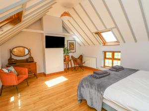 a bedroom with a bed and a desk and a television at Nanthir House in Llandrindod Wells
