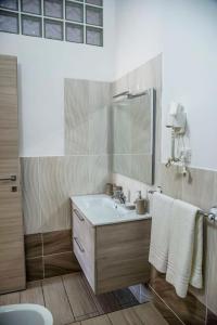 a bathroom with a sink and a mirror at Blu Mare Lampedusa Bed And Breakfast in Lampedusa