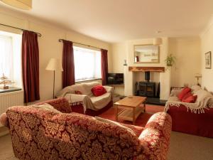 a living room with two couches and a fireplace at Little Roost in Mathry