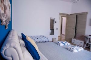 a bedroom with a large bed with blue pillows at Blu Mare Lampedusa Bed And Breakfast in Lampedusa