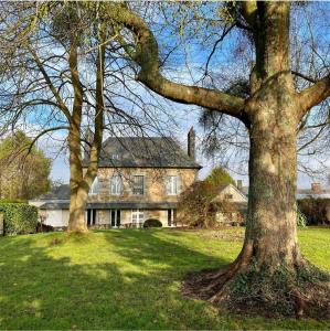 a large house with two trees in front of it at Studio Gypsy in Isigny-le-Buat