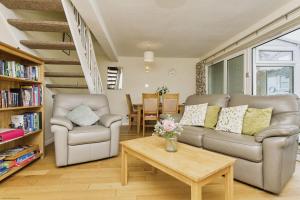 a living room with two couches and a coffee table at 3 Harbour Strand in Bembridge