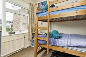 a bedroom with two bunk beds and a window at 3 Harbour Strand in Bembridge