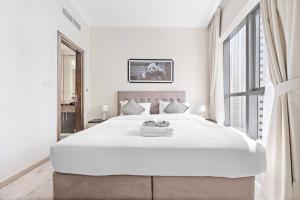 Postel nebo postele na pokoji v ubytování StoneTree - Modern 1 BR Apartment in Dubai Marina + 12 fotografií