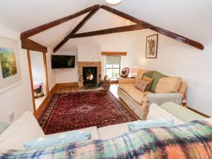 a living room with a couch and a fireplace at Hepple Hill Cottage in Consett