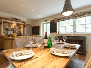 a dining room table with wine glasses on it at The Coach House in Ridingmill