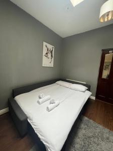 a bedroom with a bed with two towels on it at Unique Flat in the City Center in Dublin