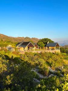 a row of houses on a hill with mountains in the background at 7 Koppies in Franschhoek