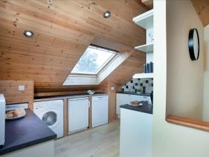 an attic laundry room with a skylight at The Old Mill House in Welcombe