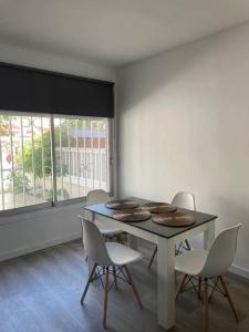 a dining room with a table and chairs and a window at Holiday home Salou in Salou