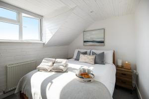 a bedroom with a bed with a bowl on it at Bright, Seaview Apartment, Beachfront, 3 bedrooms, 2 bathrooms, kid & dog friendly at The Lookout Broadstairs in Broadstairs