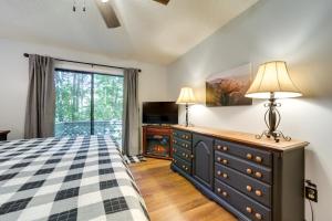 a bedroom with a bed and a dresser and a window at Peaceful Maggie Valley Vacation Rental with Fire Pit in Maggie Valley
